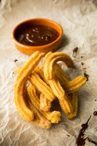 Churros, bitter chocolate sauce (Spain). Photography by Adrian Franklins