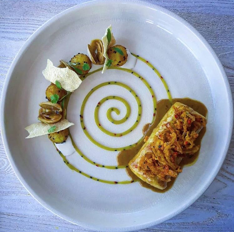 East coast hake, Bombay potatoes, Coconut curry butter emulsion, Clams, Lime chutney, Bhaji crunch by Shauna O'Keeffe. chefs to follow on Instagram, food pics, social media, The Staff Canteen, Instagram Top Ten