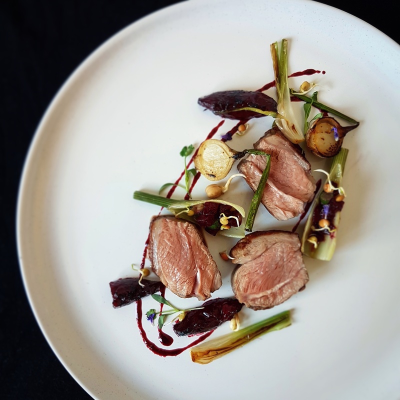 Roasted lamb rump with soy charred plums, fennel, onion bulbs, and bean sprouts by Kareem Roberts, brokedinner