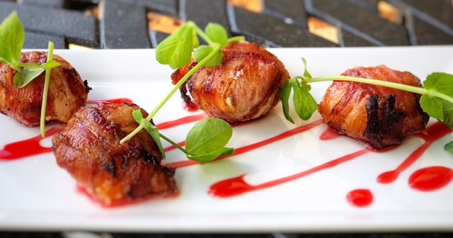 Pancetta wrapped peppadew Peppers, Goats cheese, raspberry sauce by chef Ramon Tomasini, F&D Kitchen and Bar Florida